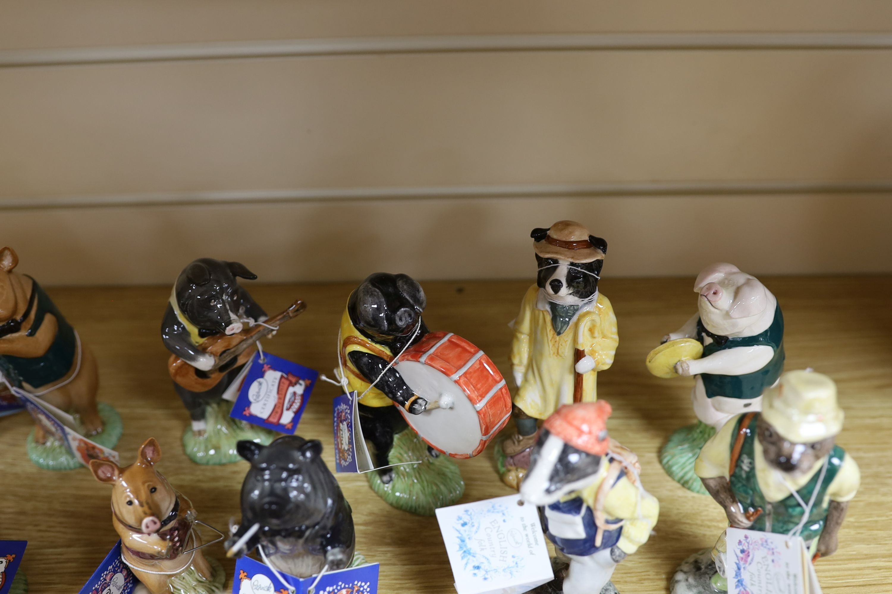 Eighteen Beswick figures, to include the Pig Promenade (10), and English Country Folk (8)